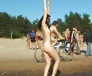 Slim teen with perky boobs naked at a nudist beach